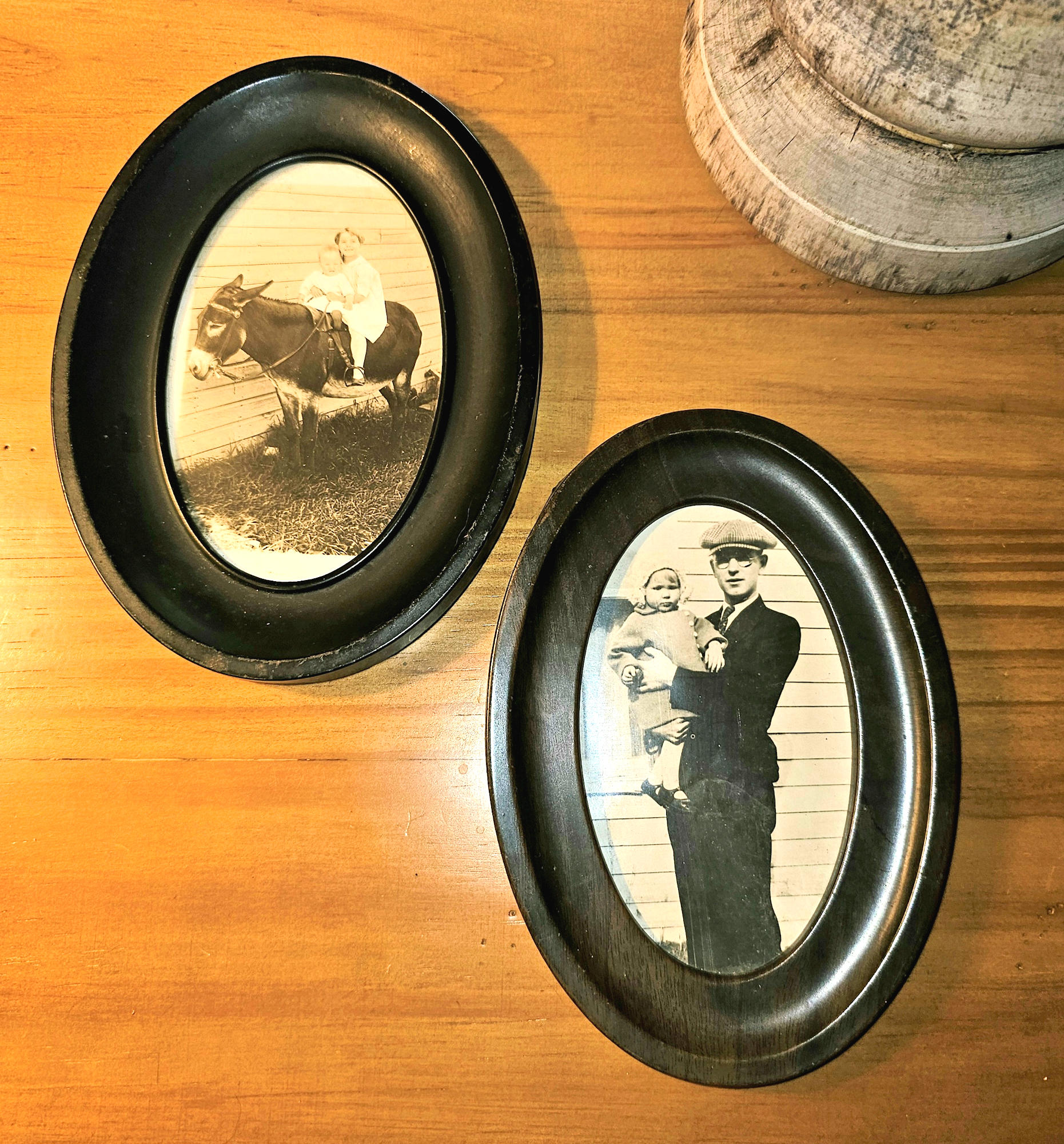 Pair of Early
                        20th‑Century Black‑and‑White Portrait
                        Photographs in Oval Metal Frames